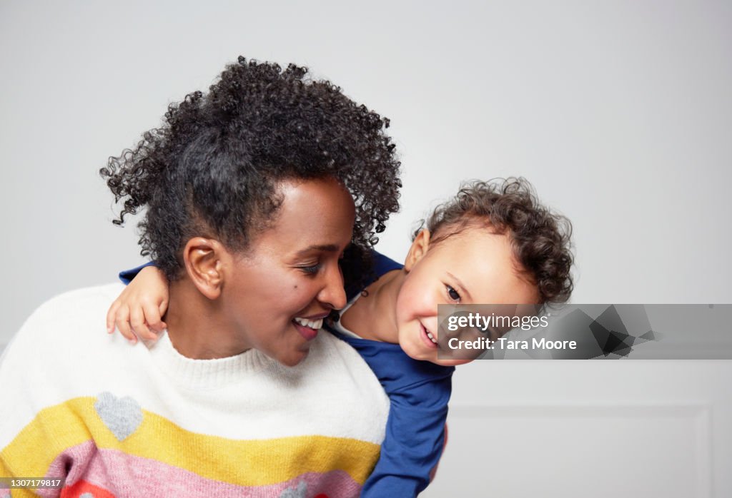 Mum piggy backing toddler