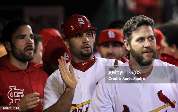 Jaime Garcia, Albert Pujols and Lance Berkman of the St. Louis Cardinals celebrate in the dugout after a two-run double by David Freese in the first...