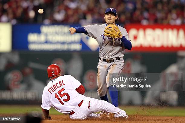 Ian Kinsler of the Texas Rangers turns the double play as Rafael Furcal of the St. Louis Cardinals slides into second base in the second inning...