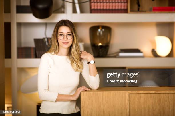 young female standing and looking at camera - leaning on elbows stock pictures, royalty-free photos & images