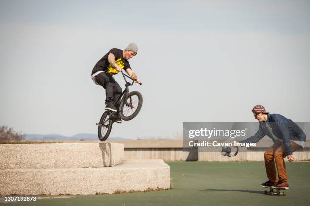 young bmx rider trying to land trick - kid bike wheelie stock pictures, royalty-free photos & images