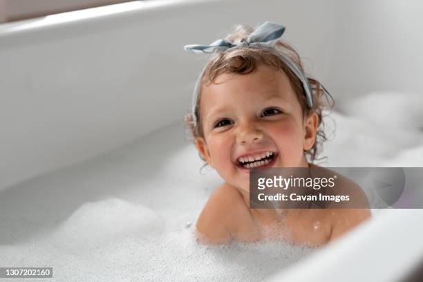 girl has fun in the bathtub - お風呂　親子 ストックフォトと画像