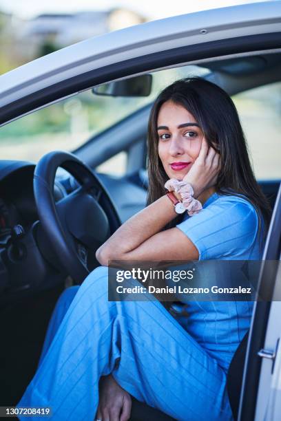 hispanic woman sitting in car - different car models stock pictures, royalty-free photos & images