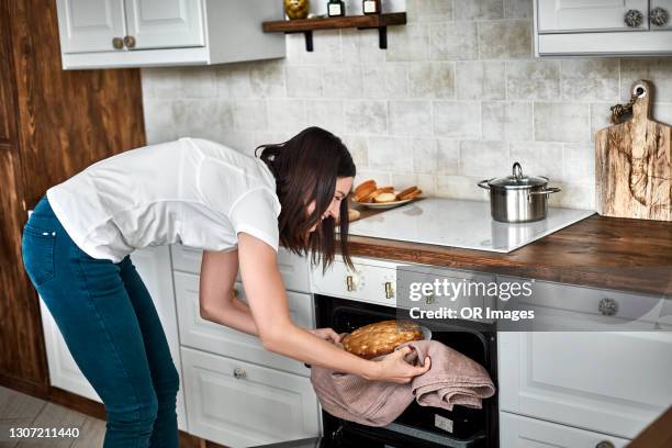 woman taking homemade cake out of oven - cake top view stock pictures, royalty-free photos & images