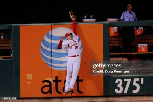 Allen Craig of the St. Louis Cardinals makes a leaping catch at the wall on a ball hit by Nelson Cruz of the Texas Rangers in the sixth inning during...