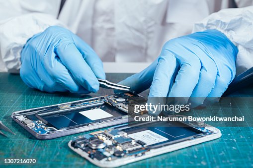The technician repairing the smartphone in the lab The technician repairing the smartphone in the lab