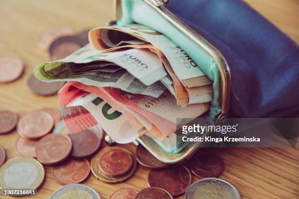 purse full of money - wallet stock pictures, royalty-free photos & images