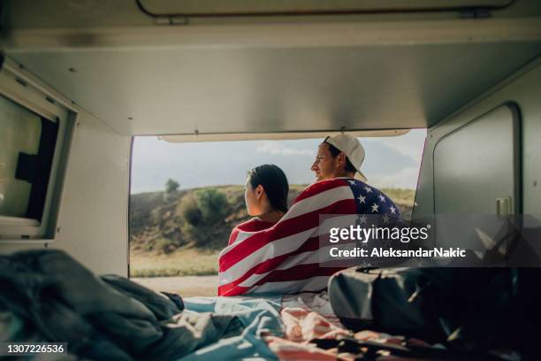 young american couple celebrating fourth of july - american flag beach stock pictures, royalty-free photos & images