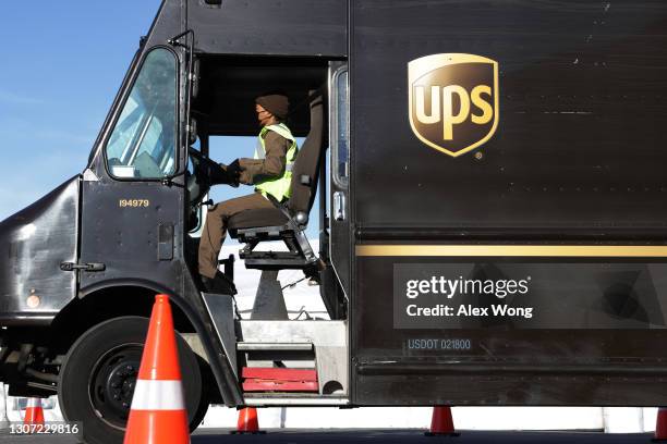 United Parcel Service driver leaves with his truck from a UPS facility that is delivering vaccines to Washington, DC, and Maryland areas March 15,...