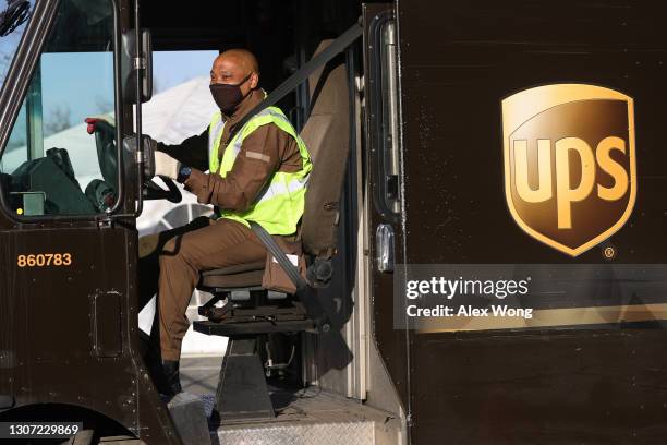 United Parcel Service driver leaves with his truck from a UPS facility that is delivering vaccines to Washington, DC, and Maryland areas March 15,...