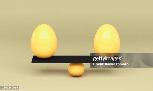 eggs balancing against background - scales balance stockfoto's en -beelden