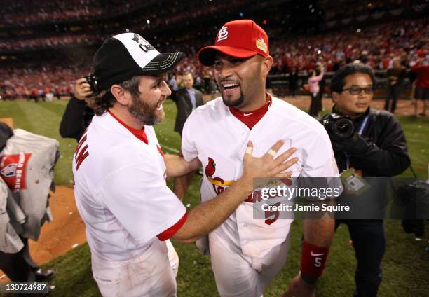 Lance Berkman and Albert Pujols of the St. Louis Cardinals celebrate after defeating the Texas Rangers 6-2 to win the World Series in Game Seven of...