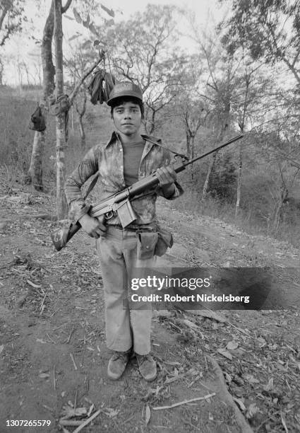 Portrait of a Fuerzas Populares de Liberacion guerilla as he poses with his weapon, near Santa Anita, Chalatenango department, El Salvador, February...