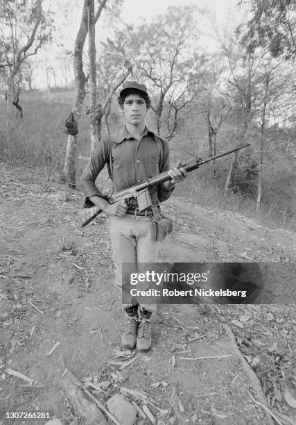 Portrait of a Fuerzas Populares de Liberacion guerilla as he poses with his weapon, near Santa Anita, Chalatenango department, El Salvador, February...