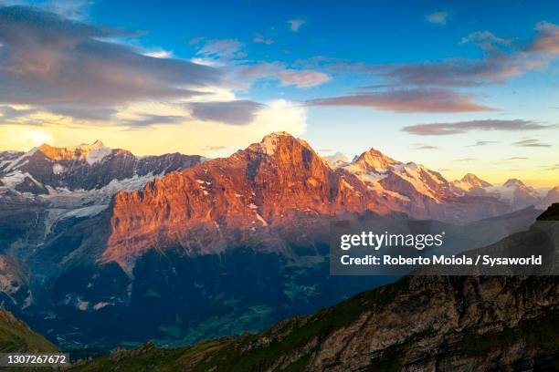 sunset on eiger and jungfrau peaks, switzerland - eiger stock pictures, royalty-free photos & images