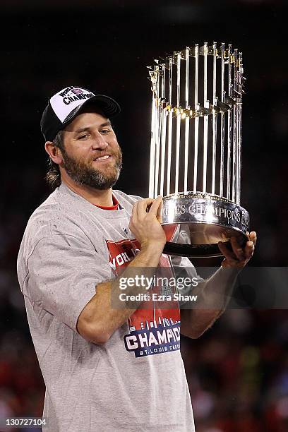 Lance Berkman of the St. Louis Cardinals holds up the World Series trophy after defeating the Texas Rangers 6-2 in Game Seven of the MLB World Series...