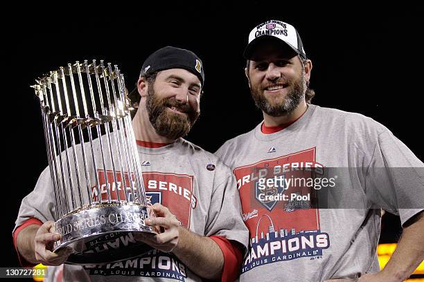 Jason Motte and Lance Berkman of the St. Louis Cardinals hold up the World Series trophy after defeating the Texas Rangers 6-2 in Game Seven of the...