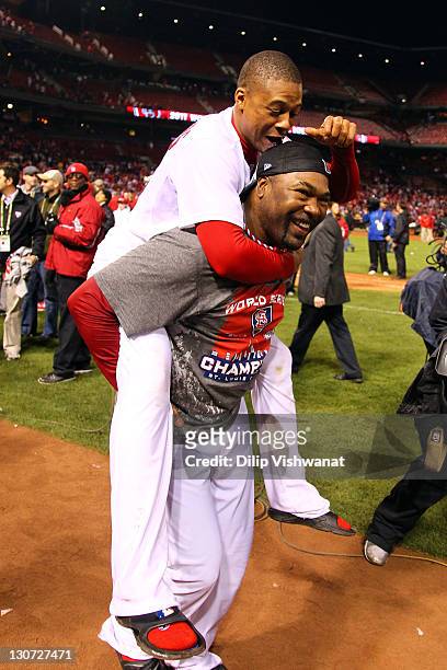 Adron Chambers and Arthur Rhodes of the St. Louis Cardinals celebrate after defeating the Texas Rangers 6-2 to win Game Seven of the MLB World Series...