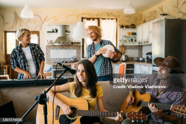 musicians having rehearsal in home studio - gig living room stock pictures, royalty-free photos & images
