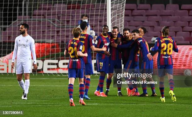 Antoine Griezmann of FC Barcelona celebrates with team mates Ousmane Dembele and Lionel Messi after scoring their side's second goal during the La...