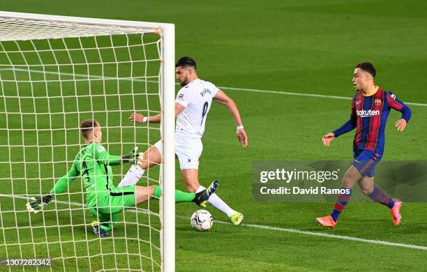 Rafa Mir of SD Huesca is fouled by Marc-Andre ter Stegen of FC Barcelona leading to a penalty being awarded during the La Liga Santander match...