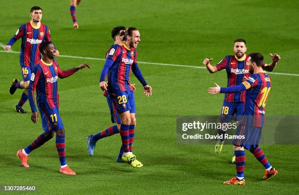 Oscar Mingueza of FC Barcelona celebrates with team mates Ousmane Dembele, Jordi Alba and Lionel Messi after scoring their side's third goal during...