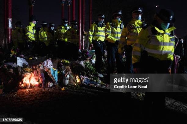 Police officers move from the bandstand area following a series of arrests during a vigil for Sarah Everard on Clapham Common on March 13, 2021 in...