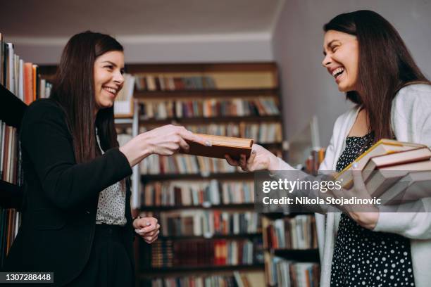 high school or college student returing library - book distribution stock pictures, royalty-free photos & images