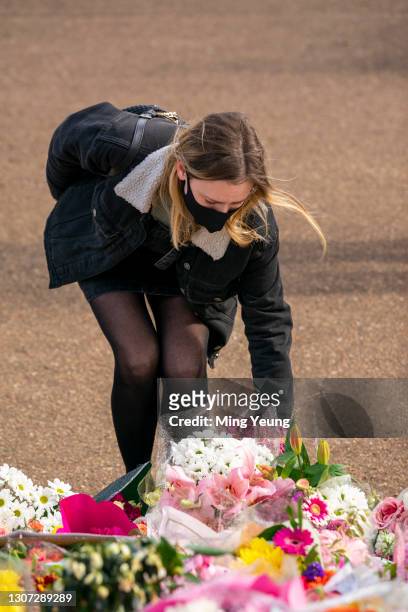 Members of the public pay their respects to Sarah Everard at the bandstand, Clapham Common, where floral tributes have been building up over the last...
