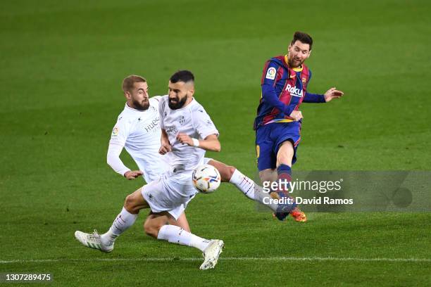 Lionel Messi of FC Barcelona scores their side's fourth goal during the La Liga Santander match between FC Barcelona and SD Huesca at Camp Nou on...
