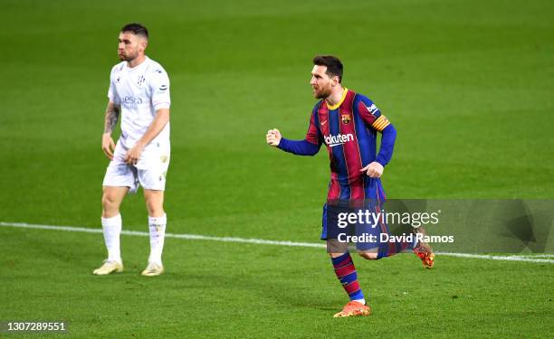 Lionel Messi of FC Barcelona celebrates after scoring their side's fourth goal during the La Liga Santander match between FC Barcelona and SD Huesca...