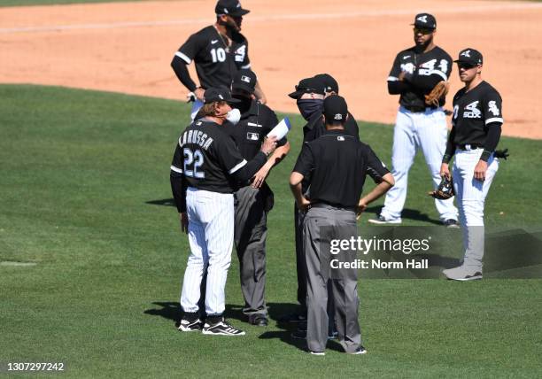 Manager Tony La Russa of the Chicago White Sox talks with the entire umpire crew after Cameron Maybin of the Chicago Cubs was caught in a run down...