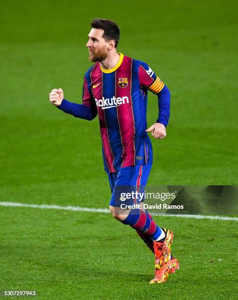 Lionel Messi of FC Barcelona celebrates after scoring his team's fourth goal during the La Liga Santander match between FC Barcelona and SD Huesca at...