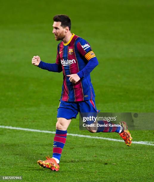 Lionel Messi of FC Barcelona celebrates after scoring his team's fourth goal during the La Liga Santander match between FC Barcelona and SD Huesca at...