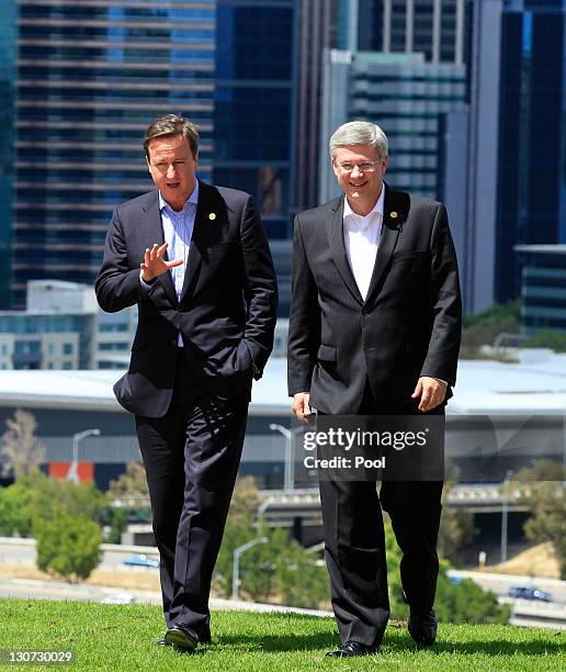 British Prime Minister David Cameron talks to his Canadian counterpart Stephen Harper during a retreat session at the Commonwealth Heads of...