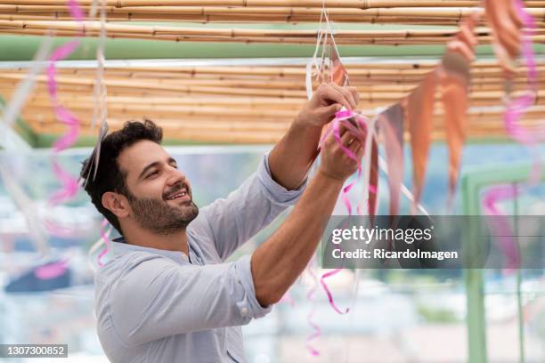 man decorates a birthday party - party preparation stock pictures, royalty-free photos & images