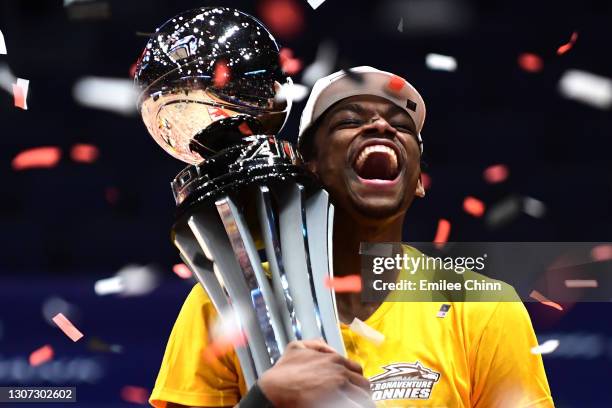 Osun Osunniyi of the St. Bonaventure Bonnies celebrates with the championship trophy following their 74-65 win over the Virginia Commonwealth Rams in...