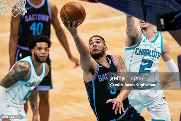 Cory Joseph of the Sacramento Kings drives to the basket past LaMelo Ball of the Charlotte Hornets during the second quarter at Spectrum Center on...