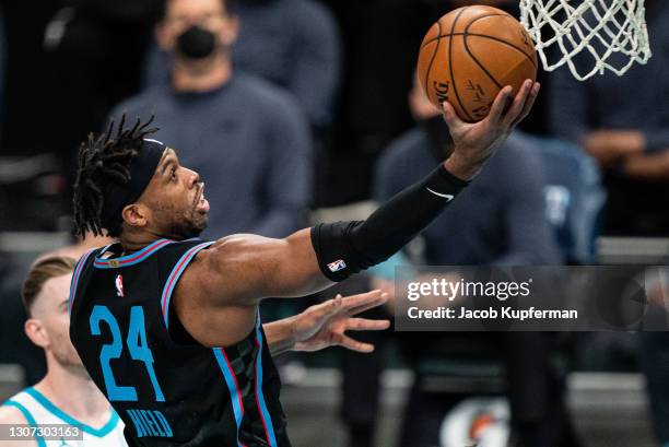 Buddy Hield of the Sacramento Kings drives to the basket against the Charlotte Hornets during the first quarter at Spectrum Center on March 15, 2021...