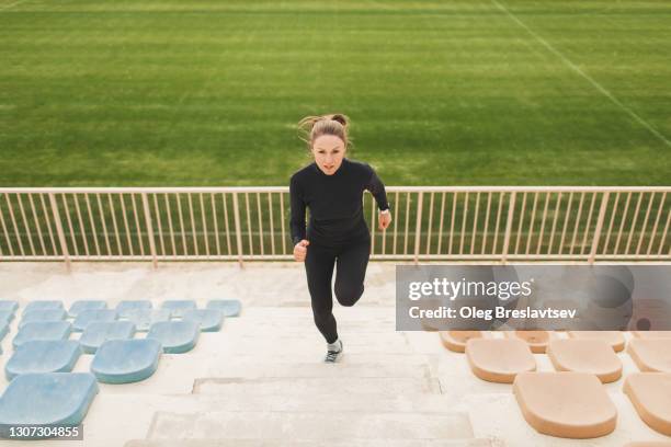 female athlete doing powerful interval running training and speed up in uphill by stairs - hiit stock pictures, royalty-free photos & images