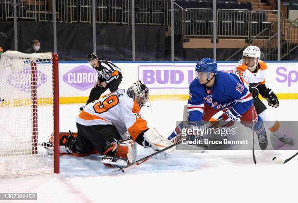 Julien Gauthier of the New York Rangers scores at 15:16 of the second period against Carter Hart of the Philadelphia Flyers at Madison Square Garden...