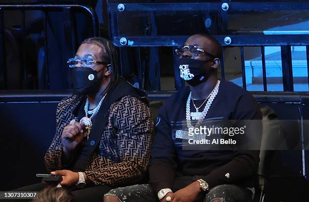 Rappers Rowdy Rebel and Bobby Shmurda watch the game between the Brooklyn Nets and the New York Knicks during their game at Barclays Center on March...