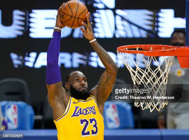 LeBron James of the Los Angeles Lakers goes up for a slam dunk against the Golden State Warriors during the first half of an NBA basketball game at...