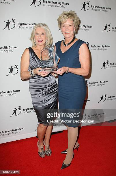 Legacy Award recipient Sandy Bilson and presenter Sarah Purcell pose for a photo with the Legacy Award after they arrive for The Big Brothers Big...