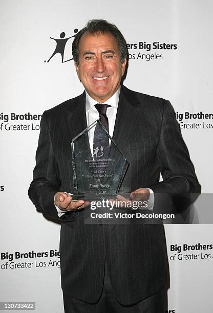 Walt Disney Man of the Year Award recipient Kenny Ortega poses for a photo with his award after arriving for The Big Brothers Big Sisters Of Greater...