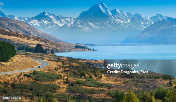 view of the road towards to mount cook along the turquoise lake pukaki. south island, canterbury, new zealand - mt cook stock pictures, royalty-free photos & images