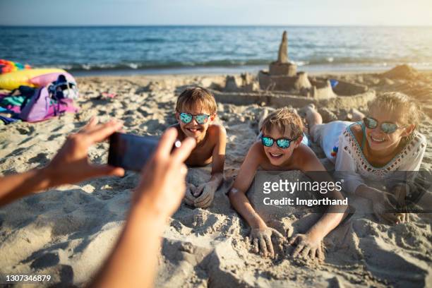 kids enjoying vacations on beach - sand castle stock pictures, royalty-free photos & images