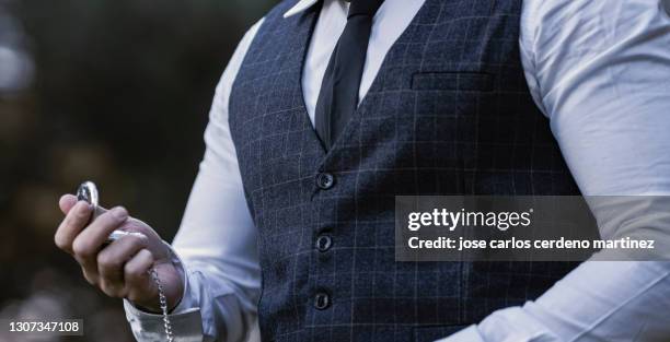 gangster mafia man with classic clothes pocket watch in nature - dead gangster stock pictures, royalty-free photos & images