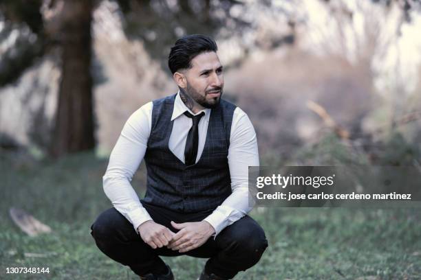 gangster mafia man with classic clothes pocket watch in nature - dead gangster stock pictures, royalty-free photos & images