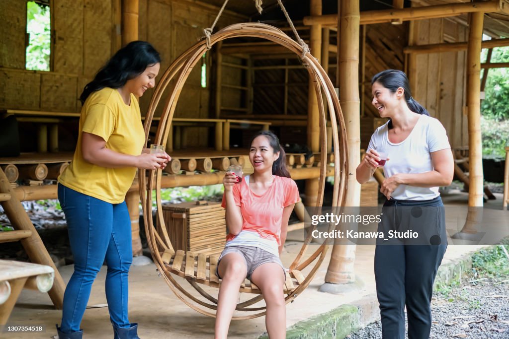 Group of Friends Chatting on a Green Building Patio
